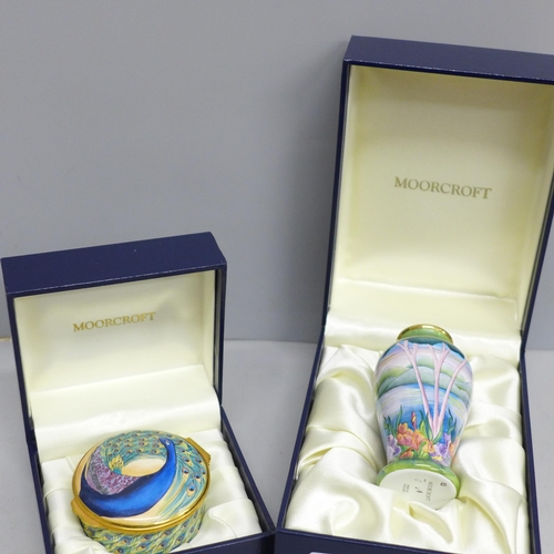 2013 - An enamelled Moorcroft miniature vase with lake scene and a similar pill box with peacock detail, bo... 