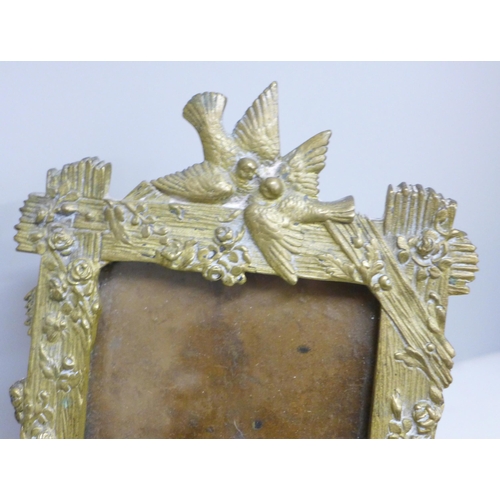 2020 - A pair of brass photograph frames with bird, flowers and lizard detail, circa 1920, possibly French,... 