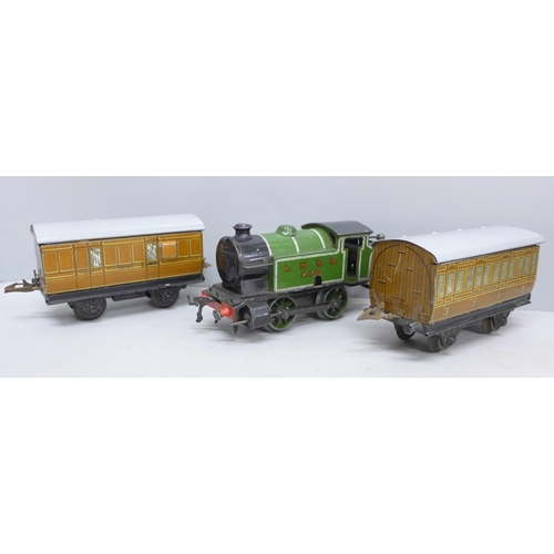 2028 - A Hornby 0 gauge type 101 clockwork locomotive and two coaches