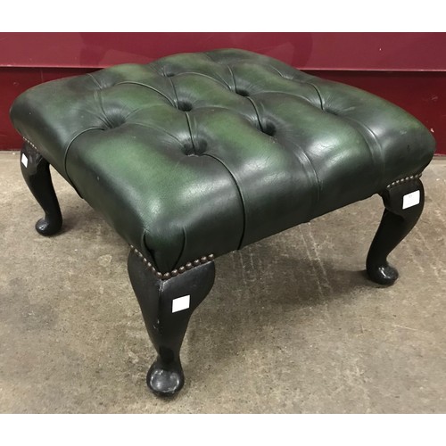 65 - A mahogany effect and green leather Chesterfield footstool