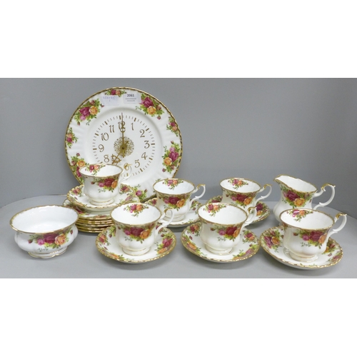 2061 - Six Royal Albert Old Country Roses cups, saucers and tea plates, a cream and sugar and a clock