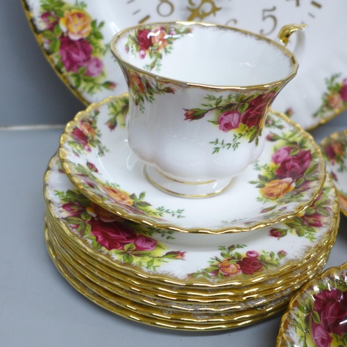 2061 - Six Royal Albert Old Country Roses cups, saucers and tea plates, a cream and sugar and a clock