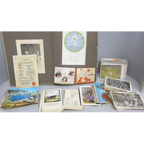 2064 - A collection of approximately 150 Edwardian and later greetings cards and postcards, and an album of... 