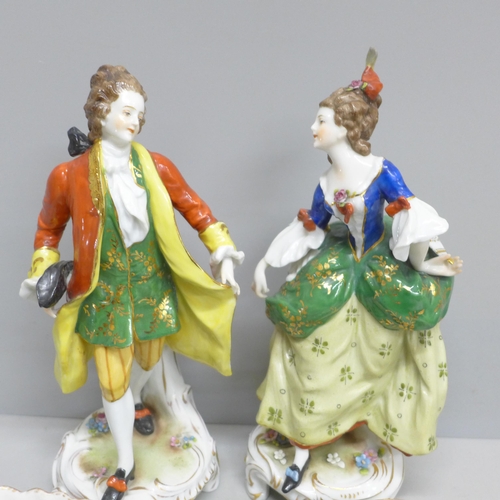 2086 - A pair of early 20th Century German porcelain figures and two Dresden cups and saucers, (fingers on ... 