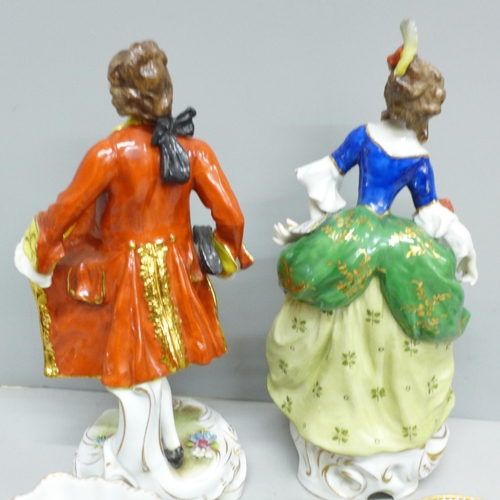 2086 - A pair of early 20th Century German porcelain figures and two Dresden cups and saucers, (fingers on ... 