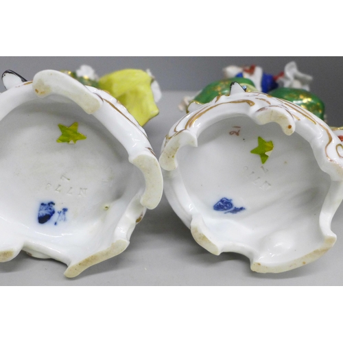 2086 - A pair of early 20th Century German porcelain figures and two Dresden cups and saucers, (fingers on ... 