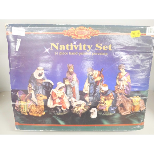 2132 - A vintage porcelain Nativity set with 11 piece hand painted porcelain. In original box.