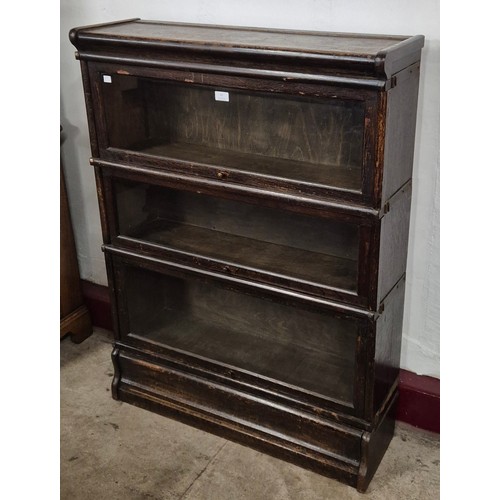 67 - An early 20th Century oak three tier sectional stacking bookcase