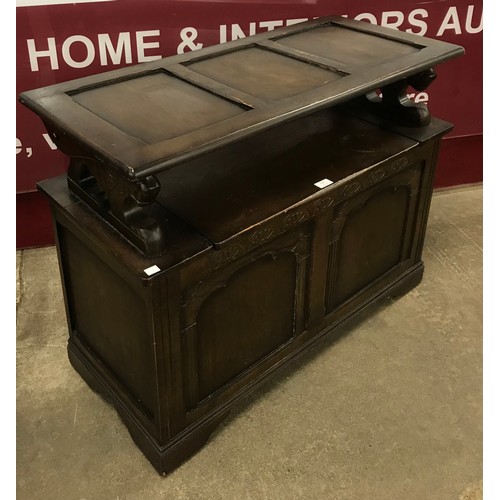 133 - An early 20th Century carved oak monks bench