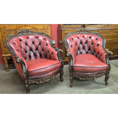 68 - A pair of French style hardwood and red leather armchairs