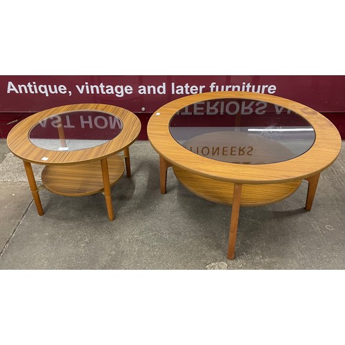 29 - Two circular teak and glass topped coffee tables