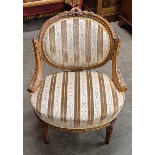 70 - A pair of French Louis XV style carved walnut and fabric upholstered fauteuil chairs