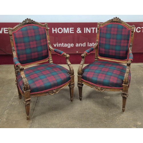 69 - A pair of French Louis XV style carved walnut and fabric upholstered fauteuil chairs