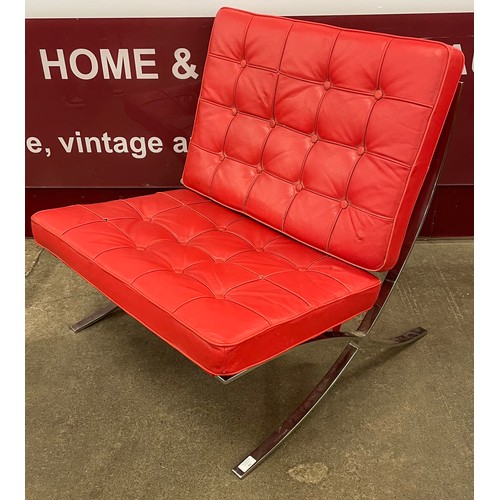 54 - A Barcelona style chrome and red leather lounge chair