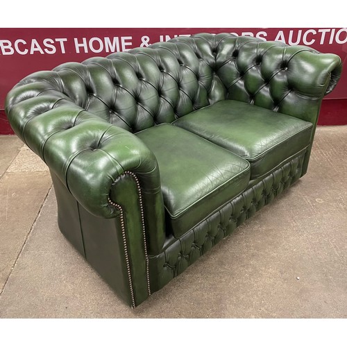 64 - A green leather Chesterfield settee