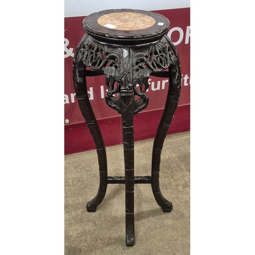 73A - A 19th Century Chinese hardwood and rouge marble topped jardiniere stand