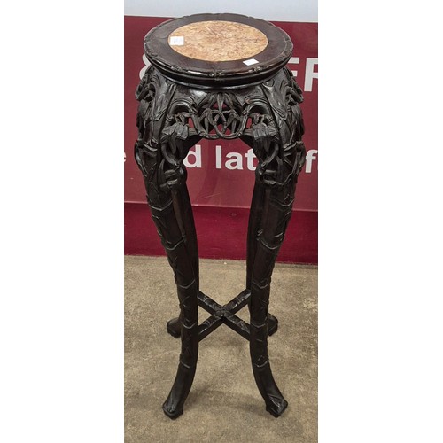 73A - A 19th Century Chinese hardwood and rouge marble topped jardiniere stand