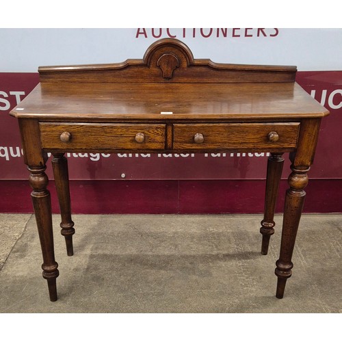 83 - A Victorian oak two drawer serving table