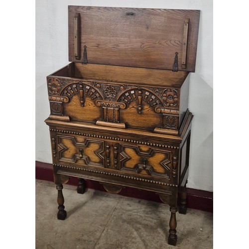 98 - An early 20th Century Elizabethan Revival oak geometric moulded cupboard on stand