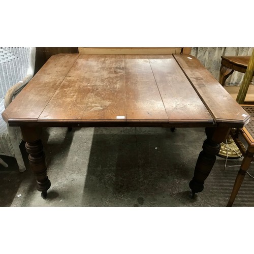 A Victorian oak dining table