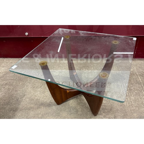 61A - A teak and glass topped coffee table