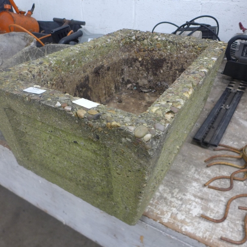 5195 - A concrete wheelbarrow planter and a concrete fox design planter and one other rectangular concrete ... 