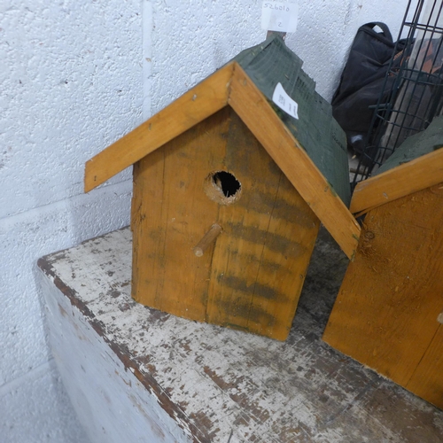 5199 - A pair of wooden bird boxes and a large triple bird feeder