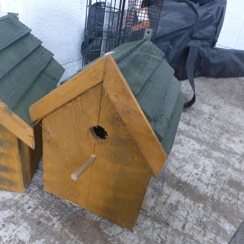 5199 - A pair of wooden bird boxes and a large triple bird feeder