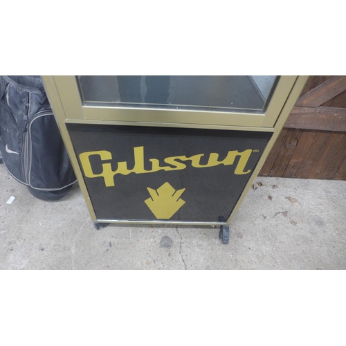 5211 - A guitar display stand with Gibson, Gretsch, Fender and Epiphone detail - item is sold with one key ... 