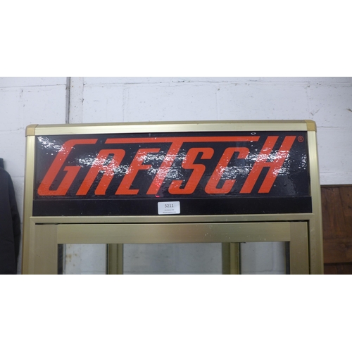 5211 - A guitar display stand with Gibson, Gretsch, Fender and Epiphone detail - item is sold with one key ... 
