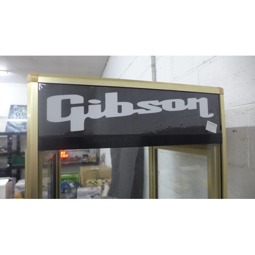 5211 - A guitar display stand with Gibson, Gretsch, Fender and Epiphone detail - item is sold with one key ... 