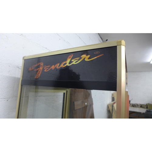 5211 - A guitar display stand with Gibson, Gretsch, Fender and Epiphone detail - item is sold with one key ... 