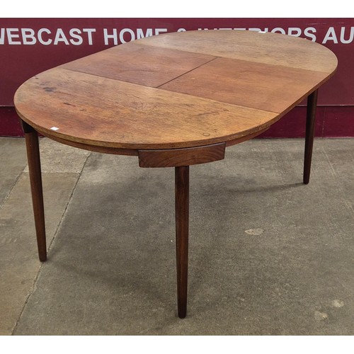 4 - A Danish Frem Rojle teak extending Roundette dining table, designed by Hans Olsen