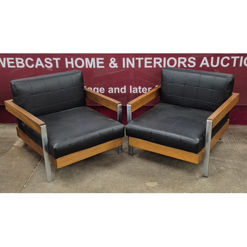 29 - A Danish style teak, chrome and black leather three piece lounge suite, comprising; two armchairs an... 