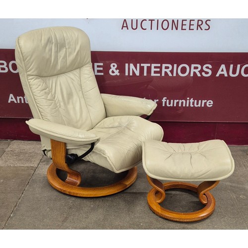 32 - A Norweigian Ekornes beech and cream leather Stressless five piece lounge suite, comprising; two rev... 