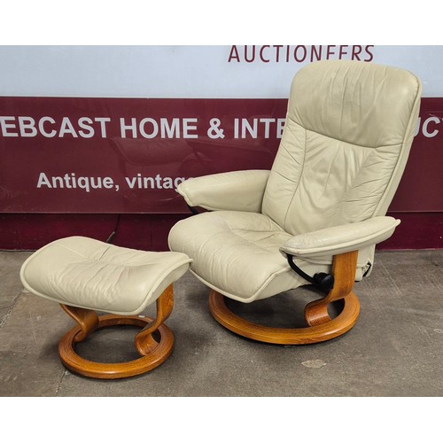 32 - A Norweigian Ekornes beech and cream leather Stressless five piece lounge suite, comprising; two rev... 