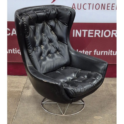 46 - A chrome and black vinyl revolving lounge chair