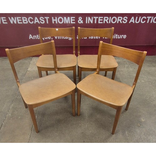 53 - A teak circular extending dining table and four chairs