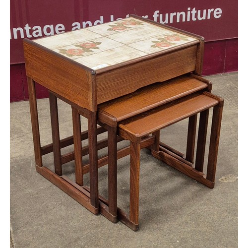 72 - A teak and tiled topped nest of tables