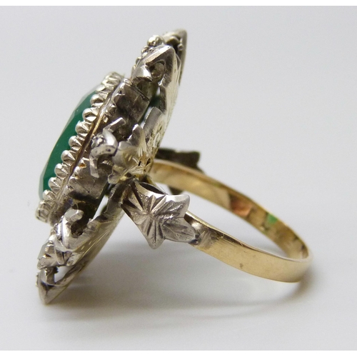 7029 - A yellow and white metal set emerald and diamond ring, stamped 18ct, 8.6g, 2.4cm, L