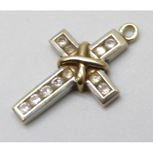 7034 - A white and yellow metal diamond set cross pendant, 1.9g, 2.1cm, lacking bale