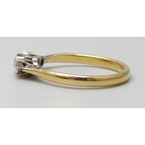 7044 - An 18ct gold three stone diamond ring, 2.6g, O