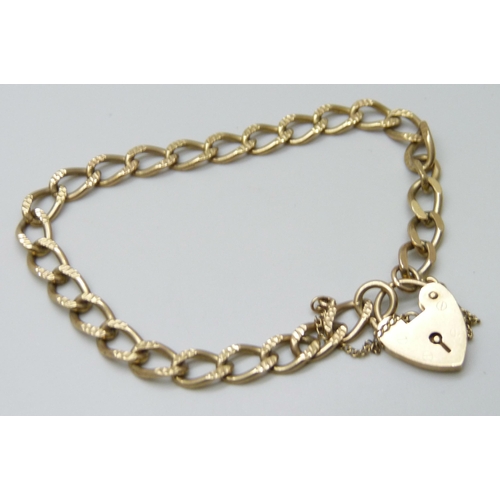 7058 - A 9ct gold curb bracelet with padlock fastener, 10.4g