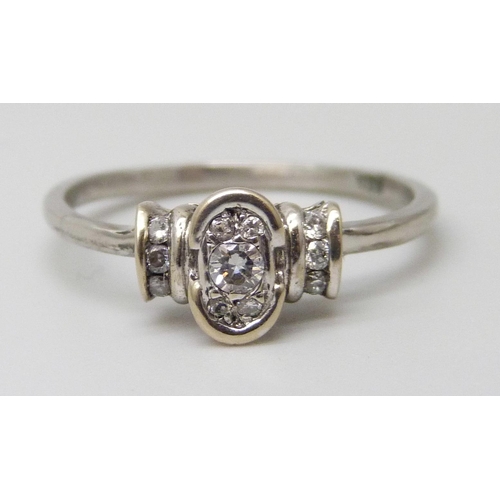 7060 - A white metal set eleven stone diamond ring, stamped 18k, 4.3g, Q