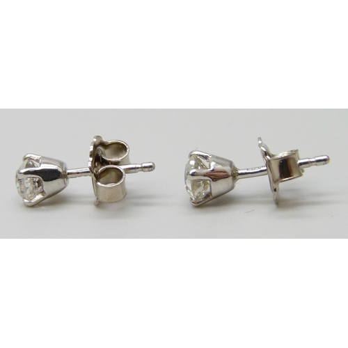 7063 - A pair of 18ct white gold diamond stud earrings, total diamond weight 0.92ct