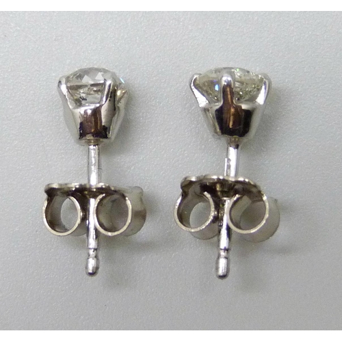 7063 - A pair of 18ct white gold diamond stud earrings, total diamond weight 0.92ct