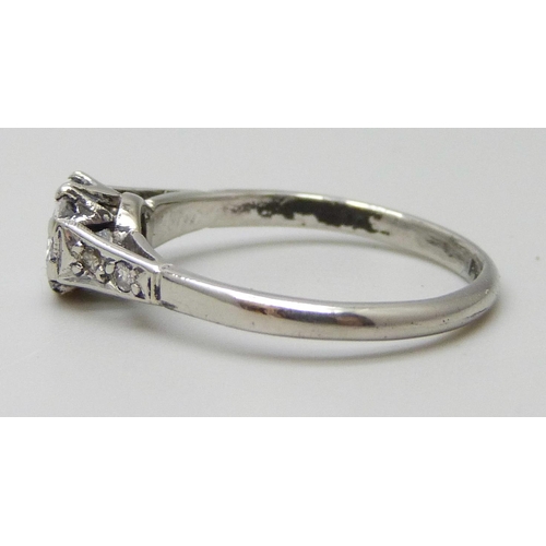 7083 - A platinum set diamond solitaire ring with diamond shoulders, approximately .70ct, 2.8g, L