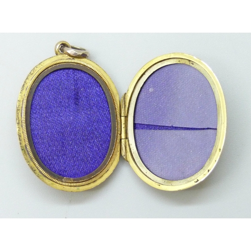 7089 - A Victorian 9ct gold locket with enamelled Art Nouveau floral design and buckle detail verso, 7.2g, ... 