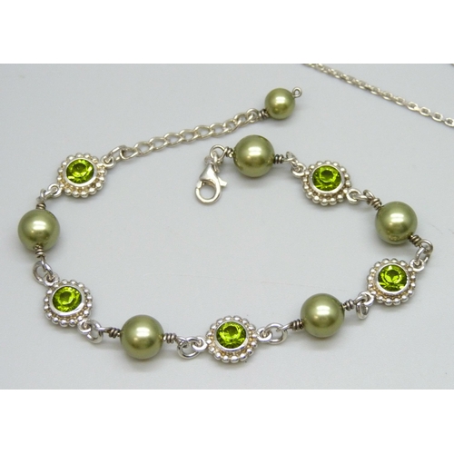 7099 - A matching silver bracelet, necklace and earrings set with pearls and green stones, 25g