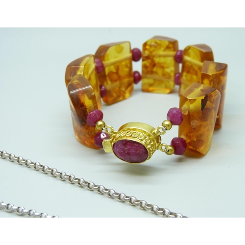 7117 - A large silver and amber pendant and chain, and an amber and ruby bracelet